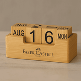 A bamboo perpetual calendar featuring wooden blocks to display the date and month, with a Faber-Castell logo. A bamboo perpetual calendar featuring wooden blocks to display the date and month, with a Faber-Castell logo.