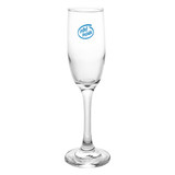 A clear glass champagne flute with a tall stem and a round base. It features a logo on the surface.