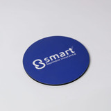 A round, blue coaster with a black underside and a white branding logo. A round, blue coaster with a black underside and a white branding logo.