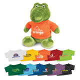 A green crocodile plush toy wearing an orange shirt, surrounded by various small t-shirt designs in multiple colours.