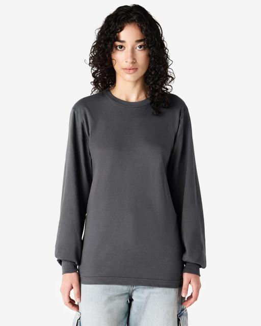 A grey long sleeve T-shirt displayed on a model, featuring a simple design and a slight stretch.