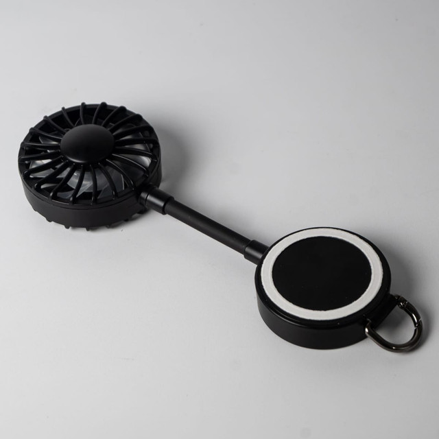 A black magnetic rechargeable fan featuring a Type C charging port, with a circular base for attachment.