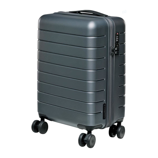 A grey wheeled carry-on suitcase with a textured exterior and four wheels for easy mobility.