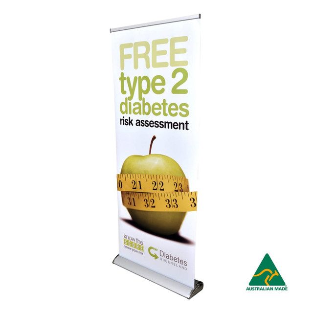 A deluxe 850mm roll-up banner featuring a green apple, a measuring tape, and a logo. Predominantly white and yellow.
