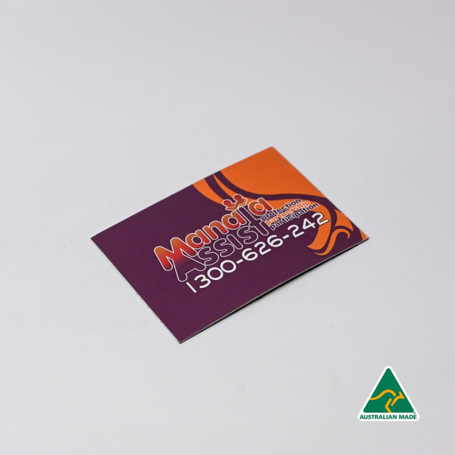 A rectangular fridge magnet featuring vibrant purple and orange colours, with a logo and contact details.