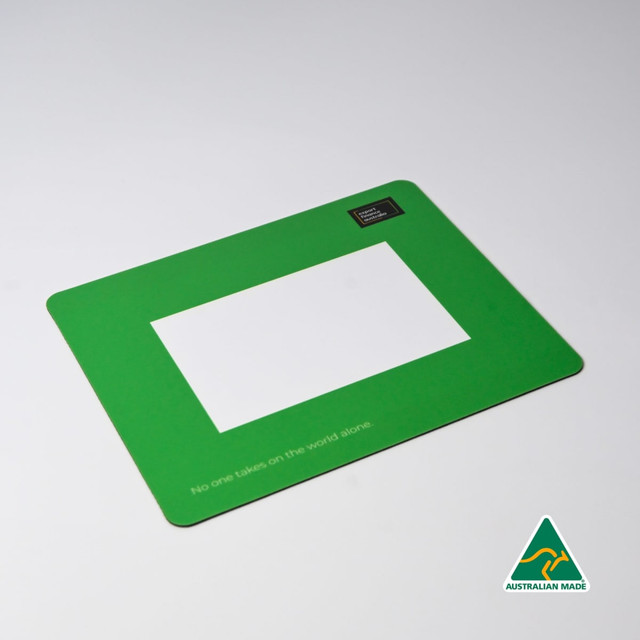 A green mouse mat featuring a central photo frame cut-out and a logo in one corner.