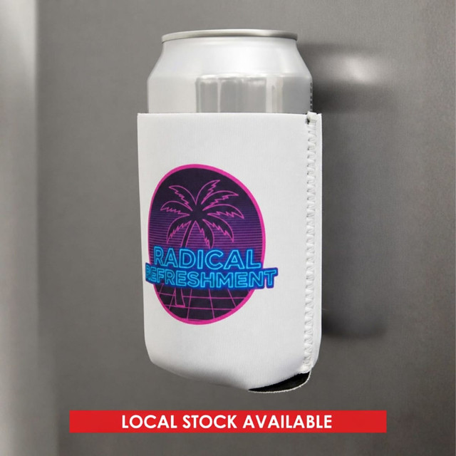 A white magnetic stubby holder featuring a palm tree and vibrant text, designed to hold a drink can securely.