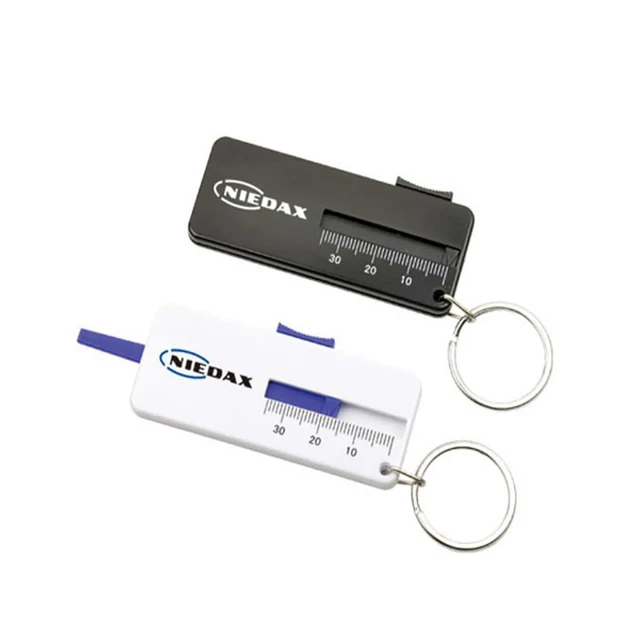 A black and a white tyre gauge, both with measuring scales and attached to a keyring.