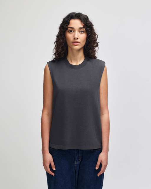 A grey unisex muscle t-shirt made from heavyweight cotton, featuring a boxy fit and sleeveless design.