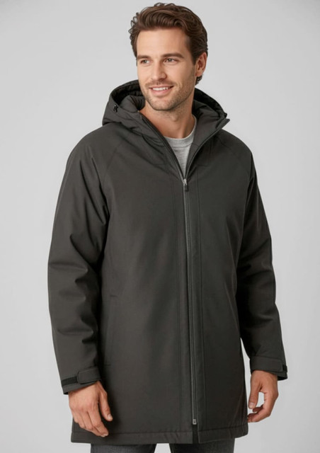 A man wearing a dark grey unisex rain jacket with a hood and a front zipper. The jacket has a logo.