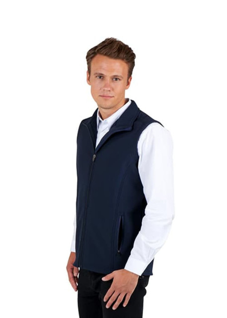 A navy soft shell vest on a model, featuring a zip front and side pockets, with a logo visible. A navy soft shell vest on a model, featuring a zip front and side pockets, with a logo visible.
