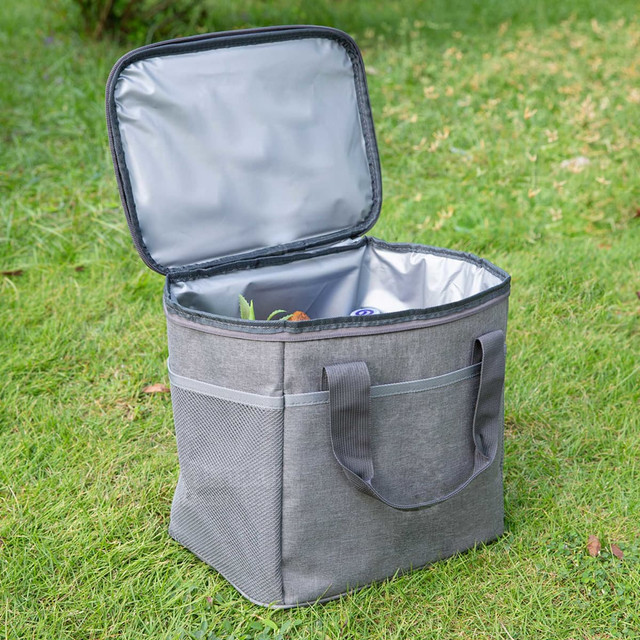 A grey nylon cooler bag with an open lid, featuring a silver interior and side pockets.