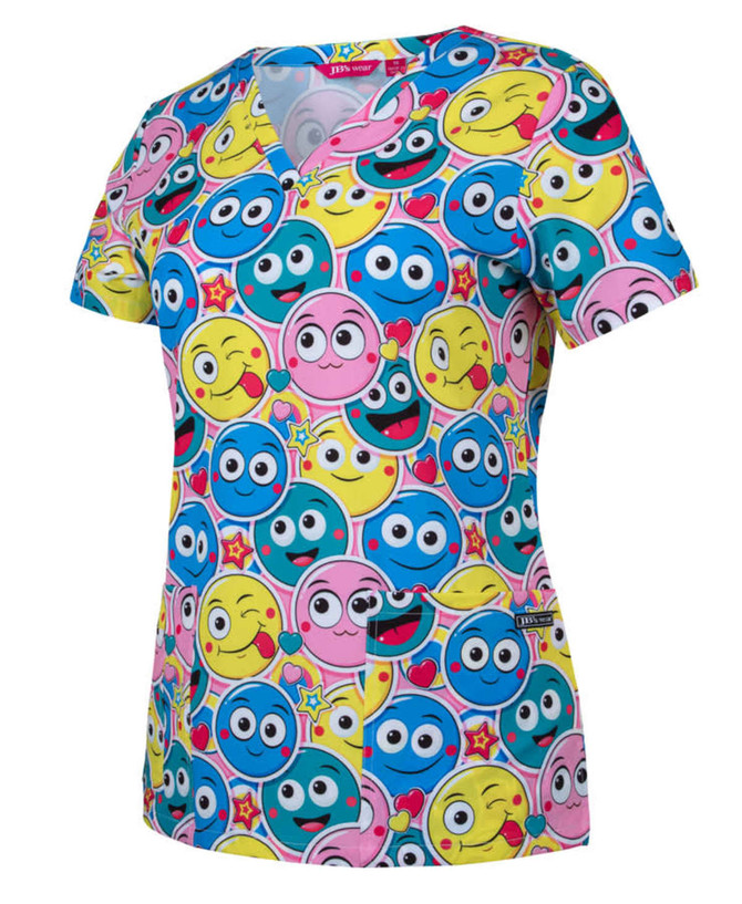 A printed scrub top featuring a vibrant design with various smiling cartoon faces in blue, pink, and yellow.