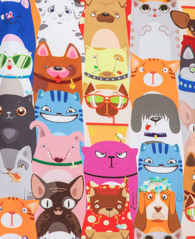 A colourful scrub top featuring various cartoon animals, including cats and dogs, in a playful printed design.