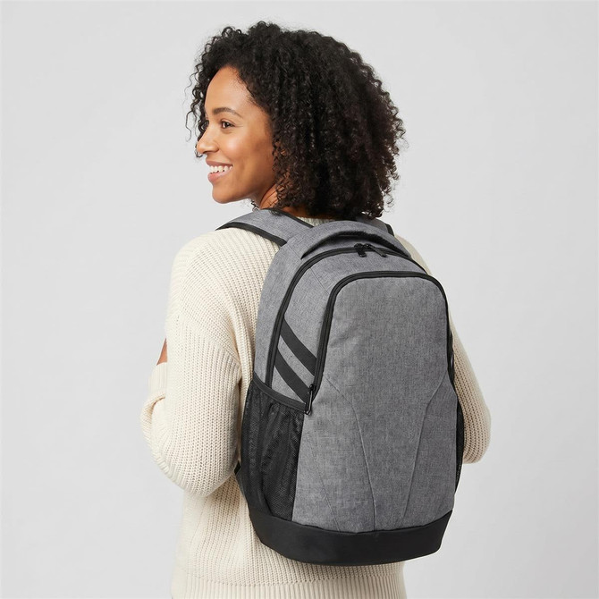 A grey laptop backpack with black accents, worn by a person with curly hair, featuring adjustable straps and side pockets.