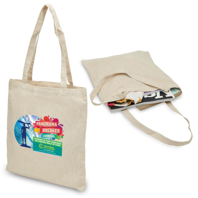 A beige hemp tote bag with two handles, featuring a logo and filled with magazines.