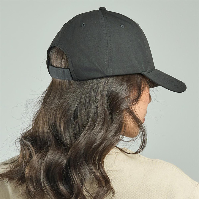 A cap in black with an adjustable strap, viewed from the back, featuring a smooth design and curved brim.