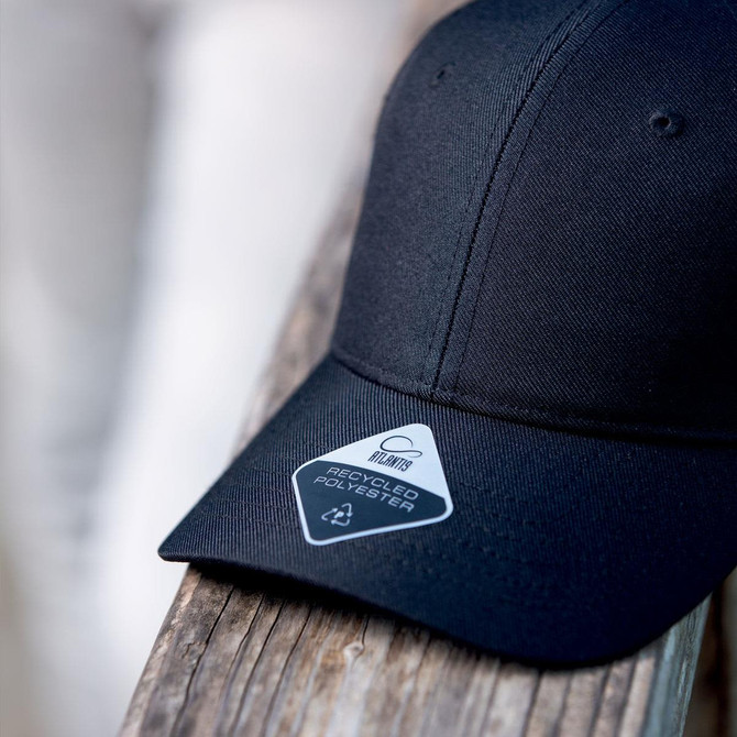 A black cap made from recycled polyester, featuring a logo and a tag indicating its eco-friendly material.