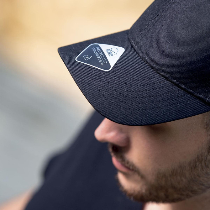 A black recycled cap with a logo on the front, featuring a curved visor.