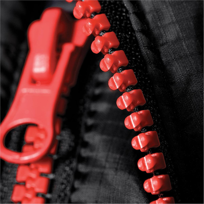A close-up of a red zipper on a black puffer jacket, with visible stitching and fabric texture.