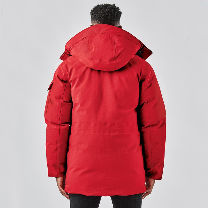 A red Men's Denali Parka with a hood, featuring a zip closure and a logo on the sleeve.