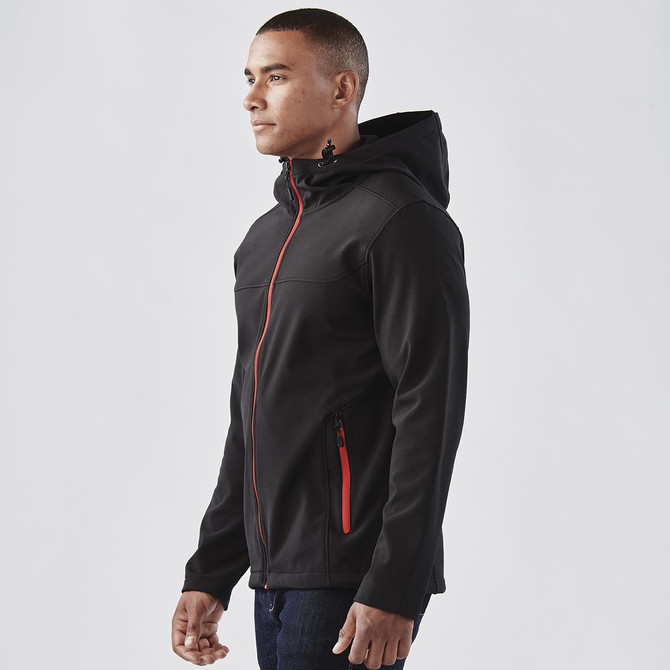A men's softshell hoody in black with red zip accents, featuring a hood and a logo on the chest.