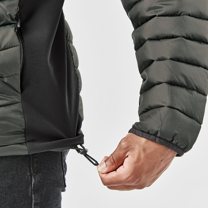 A thermal jacket in dark green with a zipped hem, featuring puffy insulation and a branded logo.