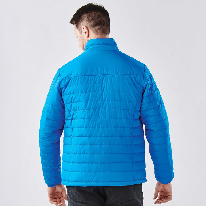A men's quilted jacket in bright blue, featuring a high collar and a textured surface, with a logo on the back.