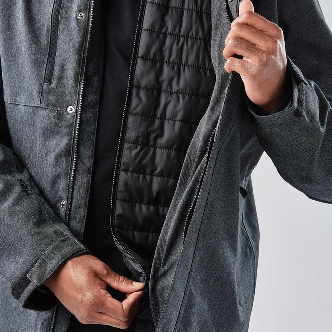 A grey men's jacket with a zippered front, featuring a quilted black lining and a person holding it open.