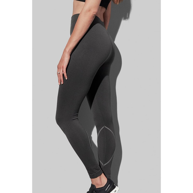Women's active seamless pants in dark grey, showcasing a fitted design and a logo detail.