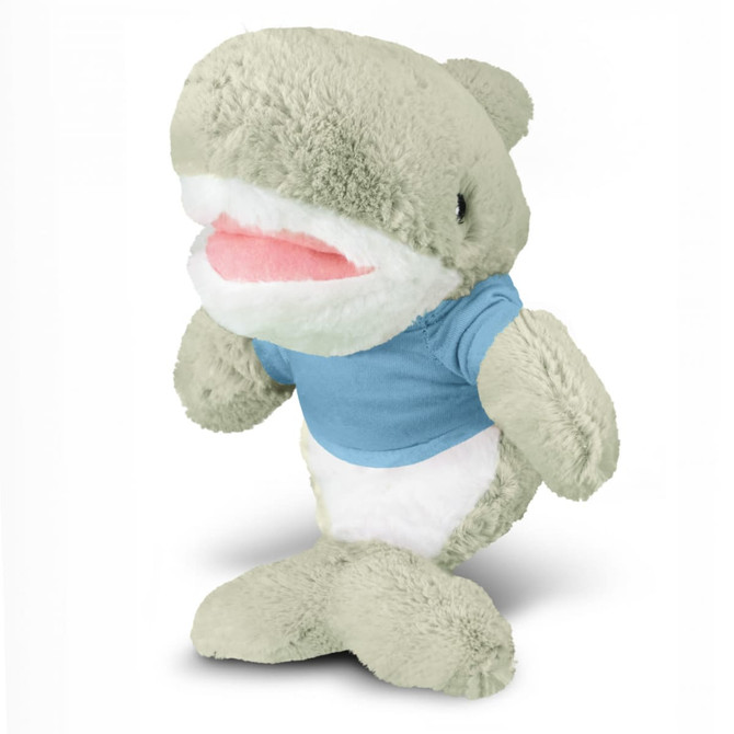 A grey shark plush toy wearing a light blue shirt, featuring a smiling face and soft, fluffy texture.