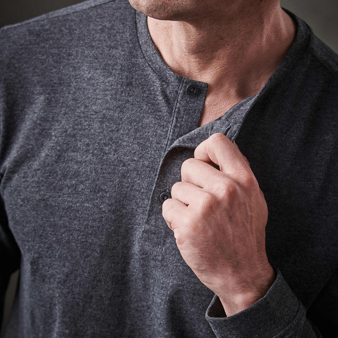 A man's long-sleeve Henley shirt in dark grey, with button detailing near the neckline and a casual fit.