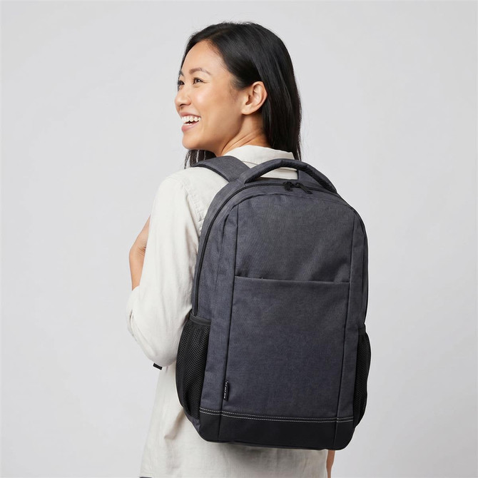 A grey and black laptop backpack is shown worn on the back of a smiling person, featuring a logo.