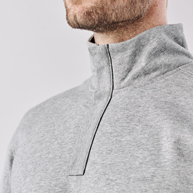 A men's grey pullover with a 1/4 zip collar, featuring a logo on the chest.