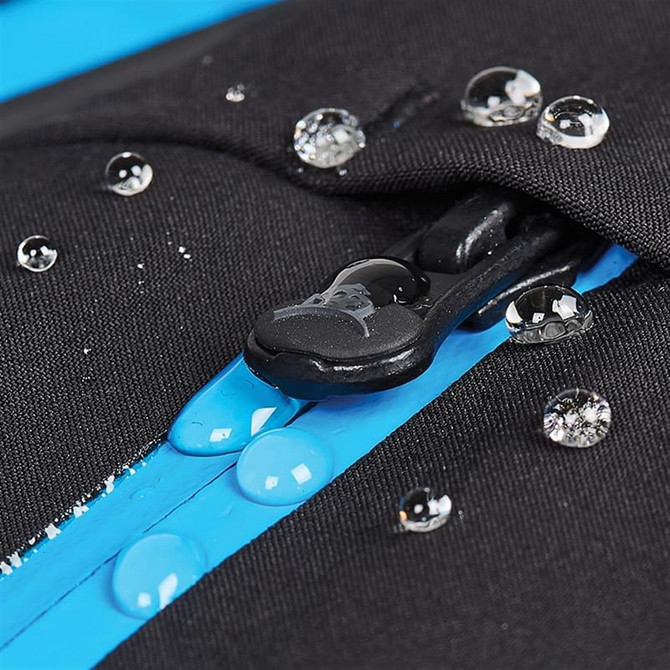 A close-up of a black softshell jacket with blue accents, featuring water droplets on the fabric and zipper.