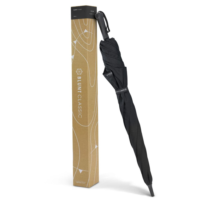 A black BLUNT Classic umbrella, displayed upright alongside its brown packaging box, featuring a logo.
