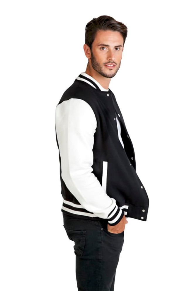 A men's varsity jacket in black with white sleeves, featuring a logo. Model is posing in profile.