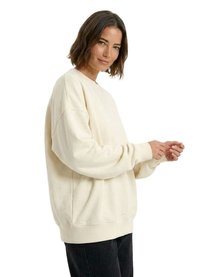 A cream oversize crew neck fleece jumper with long sleeves and a relaxed fit, featuring a branding logo.