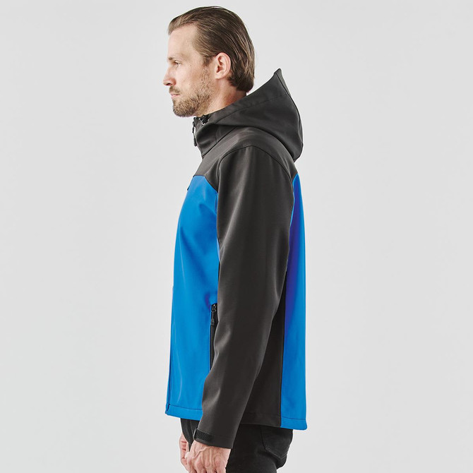 A blue and black hooded softshell jacket featuring a side zip pocket and a logo on the chest.