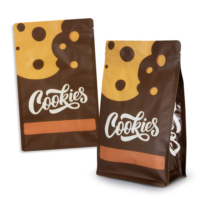 A small foil flat bottom pouch featuring a brown design with cookie graphics and a logo.