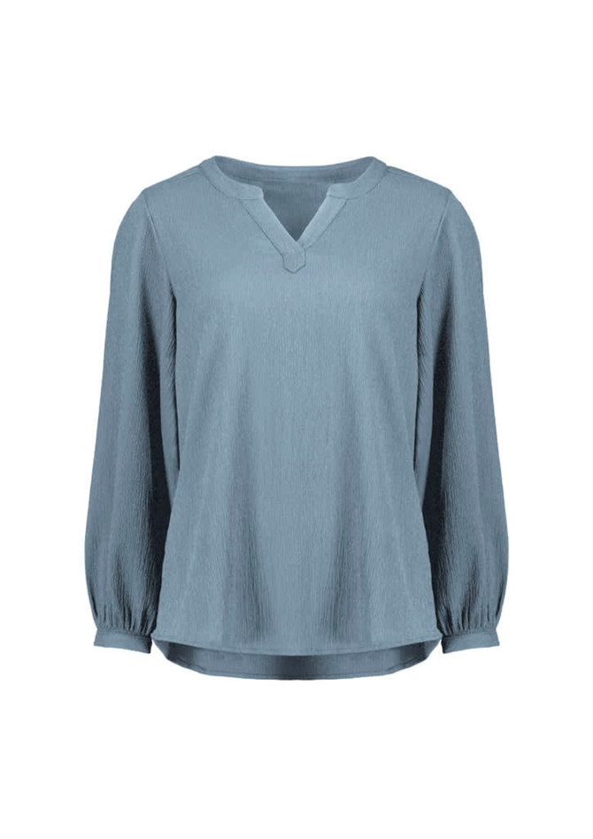 A light blue long sleeve blouse featuring a V-neck and ruché detailing. The blouse has a subtle texture and a relaxed fit.