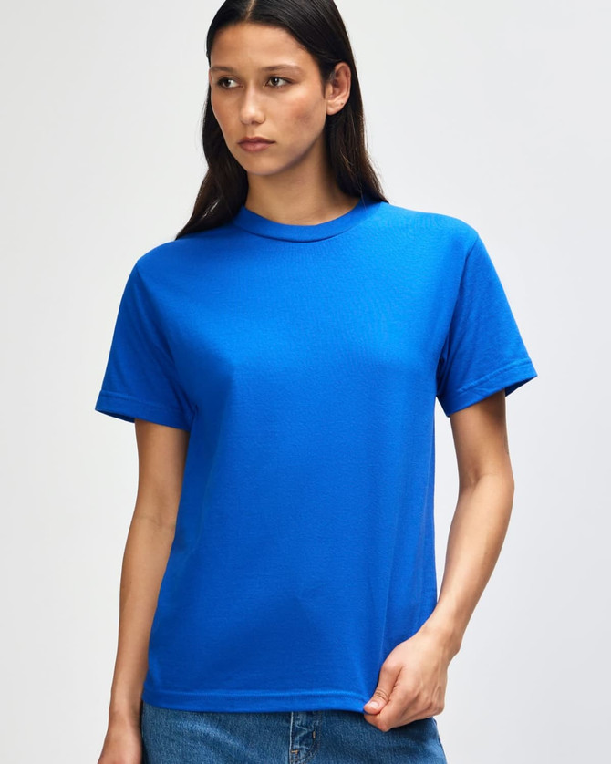 A blue heavyweight cotton unisex T-shirt displayed on a model against a plain background. It has a logo.