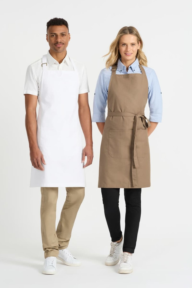 A white apron worn by a man and a khaki apron worn by a woman, both paired with casual shirts and pants.