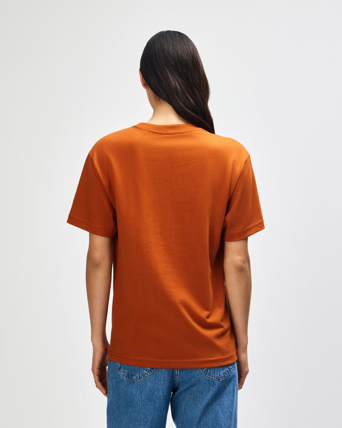 A man wearing an orange American Apparel Super Heavyweight T-Shirt, viewed from the back, with short sleeves.