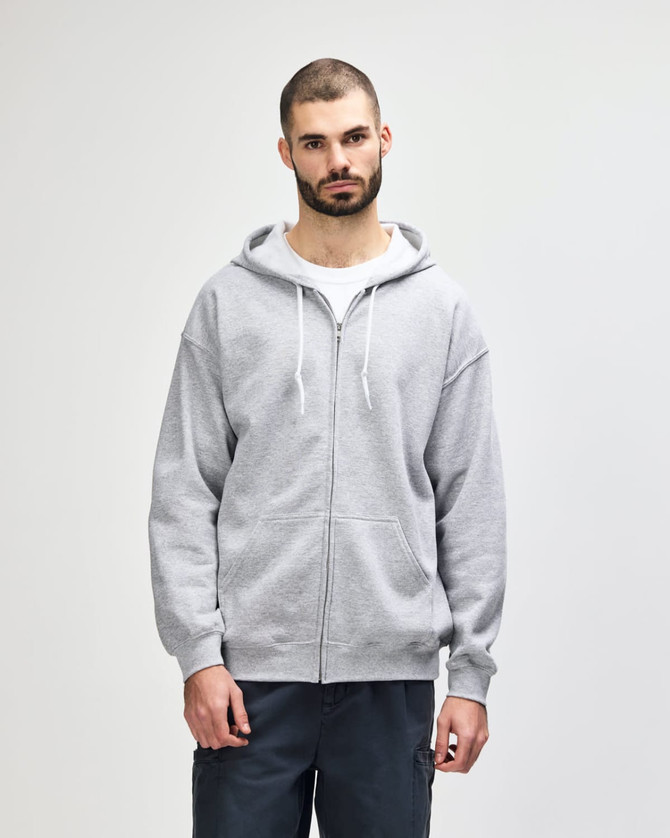 A grey full zip hooded sweatshirt worn by a man, featuring a front zipper and drawstring hood. It has a logo.