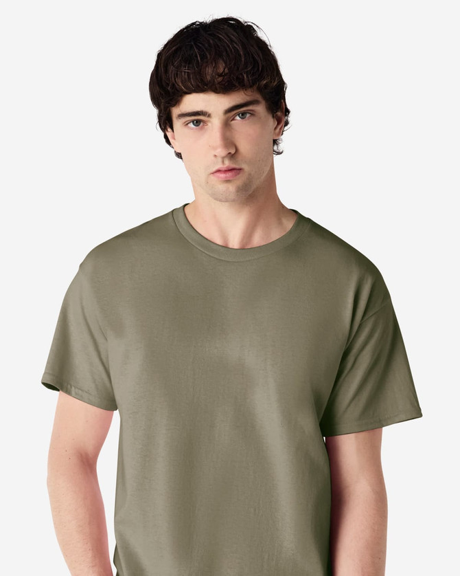 A solid olive green Gildan Ultra Cotton adult t-shirt displayed on a model. The shirt features a logo.