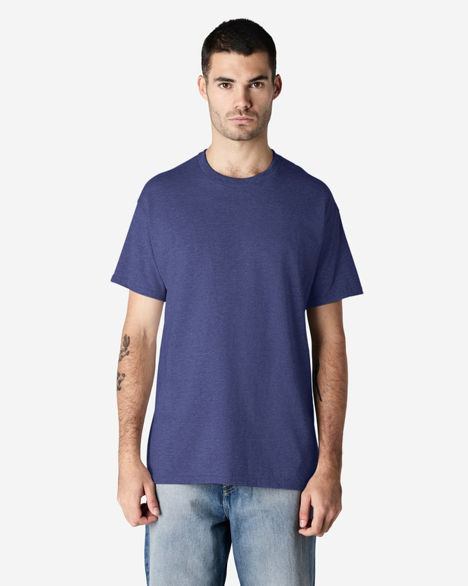 A man wearing a purple Gildan Ultra Cotton adult t-shirt and light blue jeans, standing against a plain background.