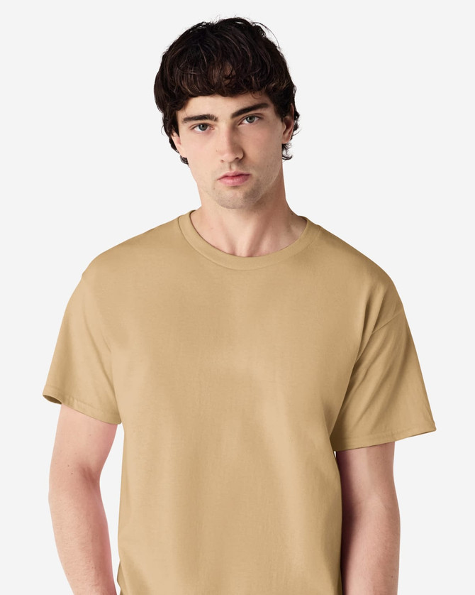 A tan Gildan Ultra Cotton adult T-shirt displayed on a model with a neutral background and a logo on the shirt.