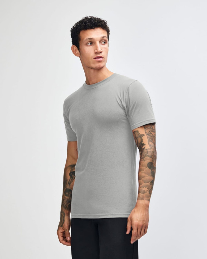 A grey unisex short sleeve t-shirt is displayed, featuring a simple design and a logo.