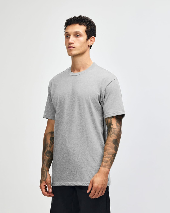 A grey unisex CVC short sleeve t-shirt displayed on a model. The shirt has a simple design and features a logo.